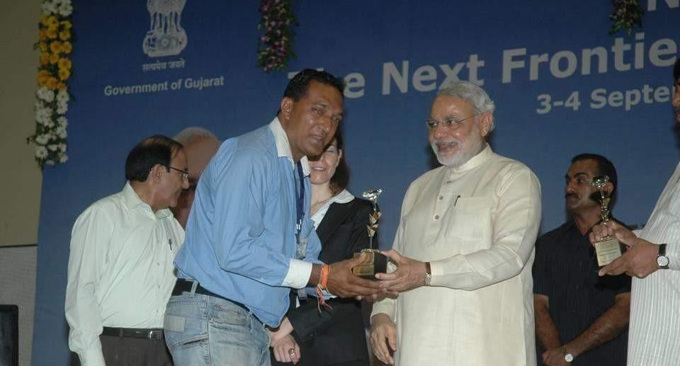 Founder receiving award from Shri Narendra Modi — Vibrant Gujarat, 2013
